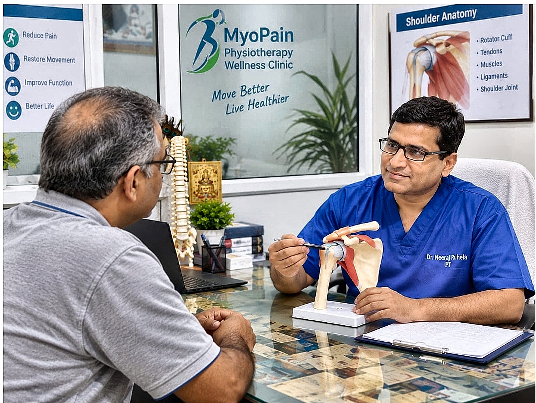 Dr. Neeraj Ruhela (PT) explaining shoulder anatomy and discussing an active recovery plan with a patient at MyoPain Physiotherapy Wellness Clinic